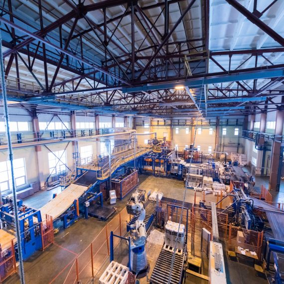Fiberglass production industry equipment at manufacture background Factory workshop interior and machines on glass production background